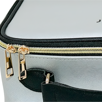 Gray suitcase with gold zipper and black accents on a light gray background